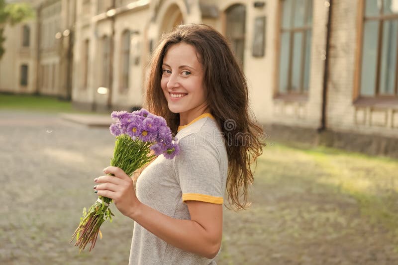 Flowers delivery service. Adore fresh flowers. Floral shop. Springtime bloom. Natural beauty concept. Gentle flower for. Delicate woman. Pure beauty. Girl hold stock photography Flowers delivery service. Adore fresh flowers. Floral shop. Springtime bloom. Natural beauty concept. Gentle flower for. Delicate woman. Pure beauty. Girl hold stock photography
