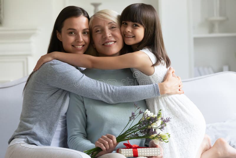 Three female generations celebrating International Womens Day looking at camera