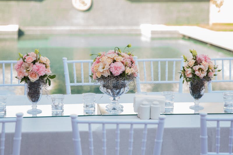 Flowers in a Glass Cup. Flowers on a Glass Table. Flowers in a Glass Cup. Flowers on a Glass