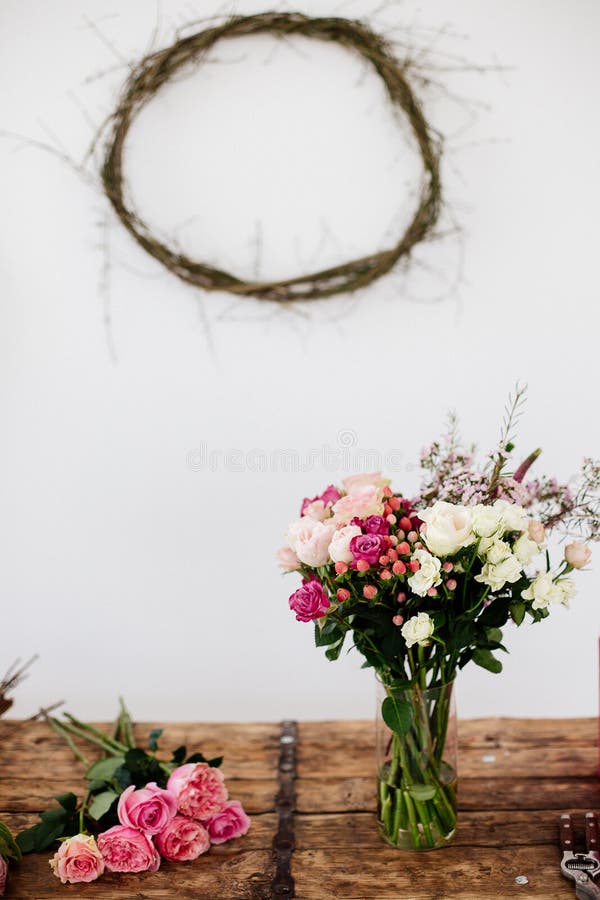 Beautiful flowers pink and white in a vase on a wooden table in a bright room. Beautiful flowers pink and white in a vase on a wooden table in a bright room.