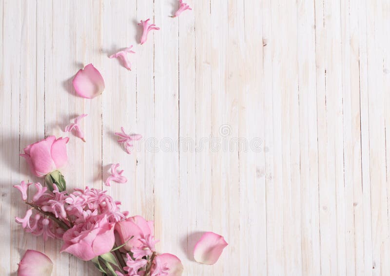 Flowers in waffle cone on white wooden background