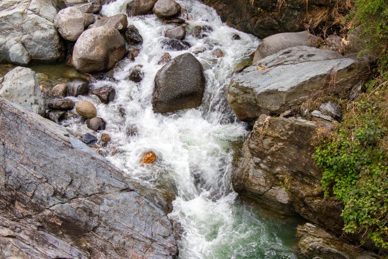 Flowing stream through green mossy rocks in forest, stock photography Flowing stream through green mossy rocks in forest, stock photography