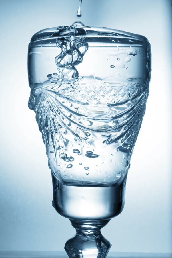 Flowing water in glass stock image. Image of vertical 15974519