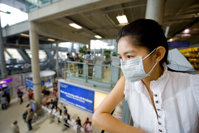 With flu mask at the airport