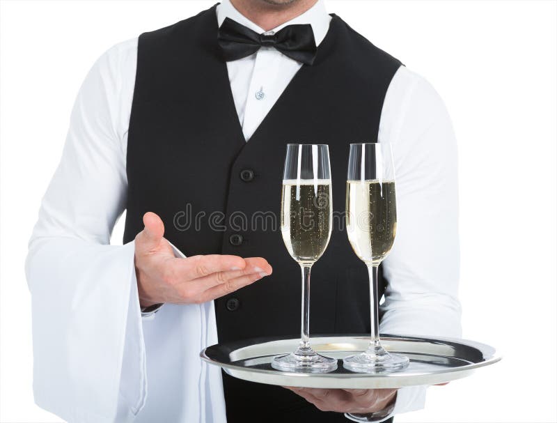 Midsection of waiter carrying champagne flutes on tray over white background. Midsection of waiter carrying champagne flutes on tray over white background