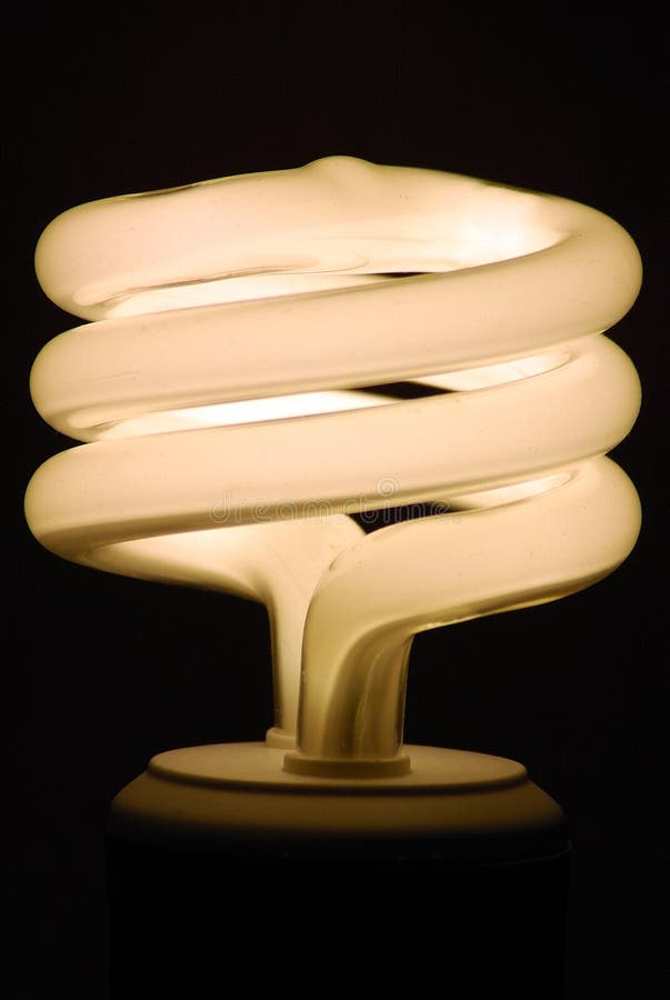 Glowing Compact Fluorescent Light Bulb with Spiral Tube on a Black