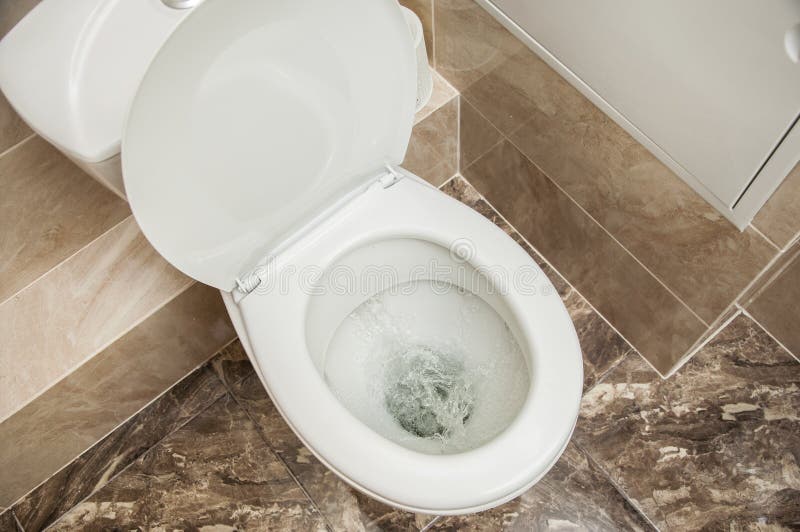 Flushing the toilet. A strong whirlpool of water in the toilet