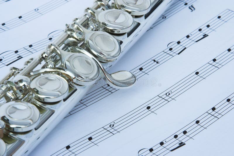 Flute keys on music notes stock photos Flute keys on music notes stock photos