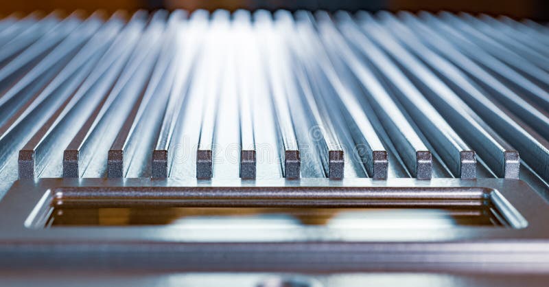 Close-up of a fluted metal surface next to a control panel on an unidentified automatic control device in a factory. The concept of secret military production