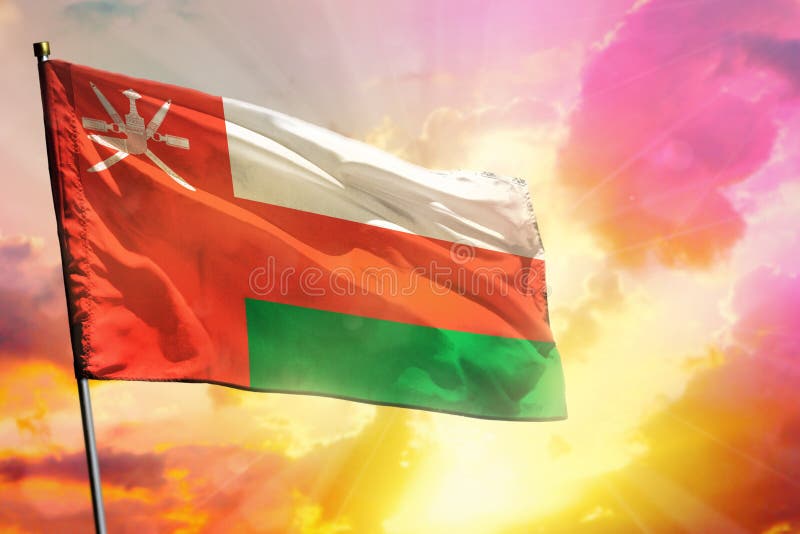 Fluttering Oman flag on beautiful colorful sunset or sunrise background. Success concept royalty free stock images