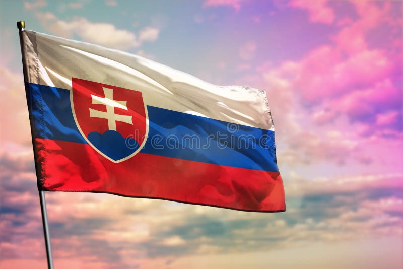 Fluttering Slovakia flag on colorful cloudy sky background. Prosperity concept