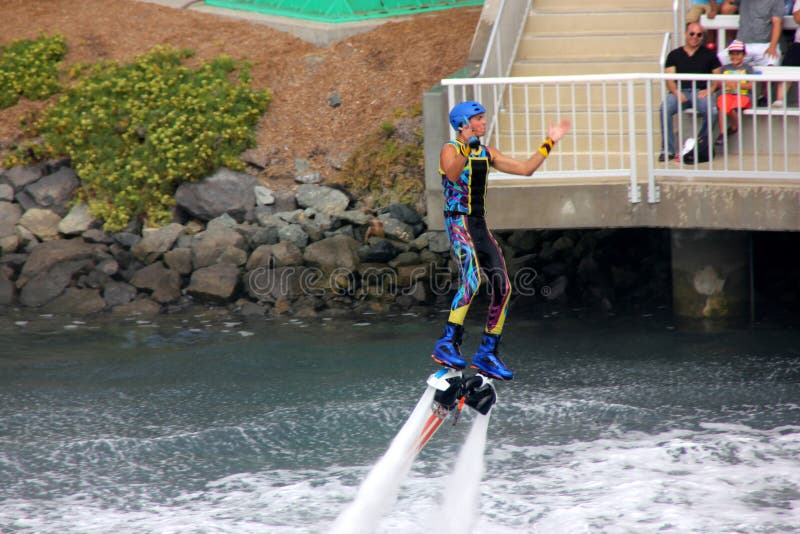 Flyboarding at Cirque De La Mer Show, SeaWorld, San Diego, California, USA, HydroJet propulsions taking artist several feet high with turns, flips, and dives midair, skyboarding. Flyboarding at Cirque De La Mer Show, SeaWorld, San Diego, California, USA, HydroJet propulsions taking artist several feet high with turns, flips, and dives midair, skyboarding