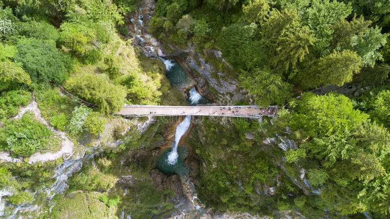 Flyg- sikt av en fot- bro till och med en klyfta med en vattenfall, bästa sikt royaltyfri foto Flyg- sikt av en fot- bro till och med en klyfta med en vattenfall, bästa sikt royaltyfri foto