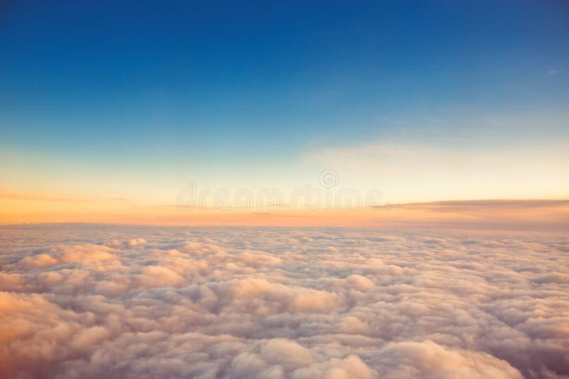 Flying above the clouds. view from the airplane, sunset shot