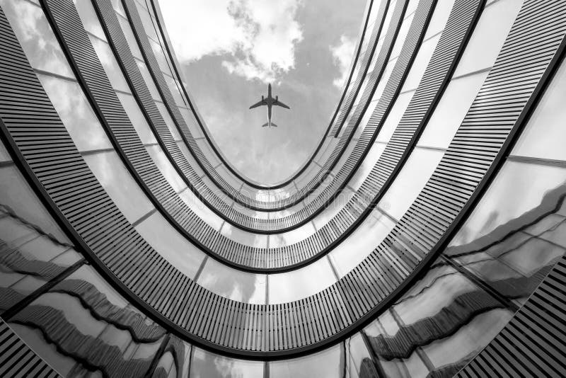Flying airplane and modern architecture building