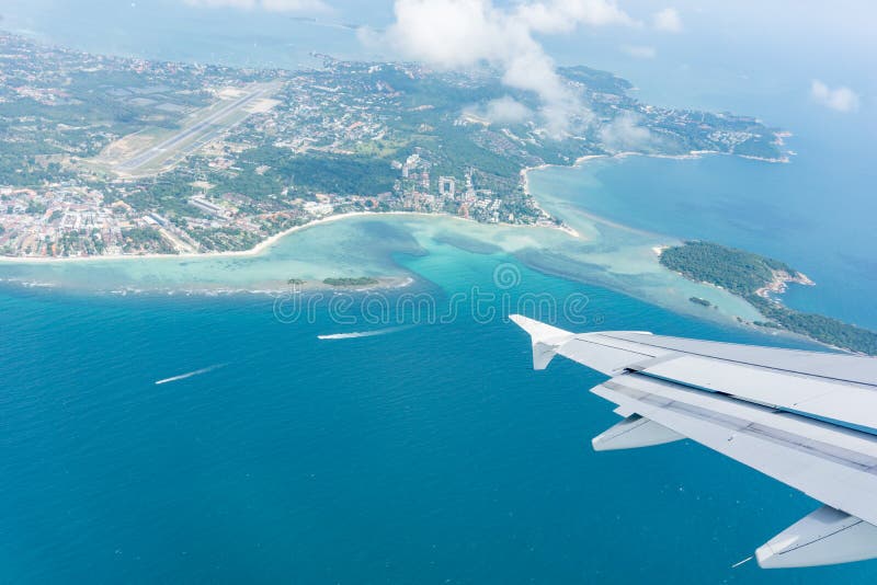 Flying away from Ko Samui from plane window island and sea below