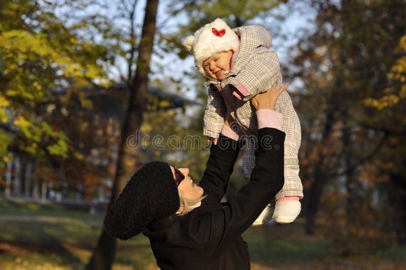 Flying baby in autumn park