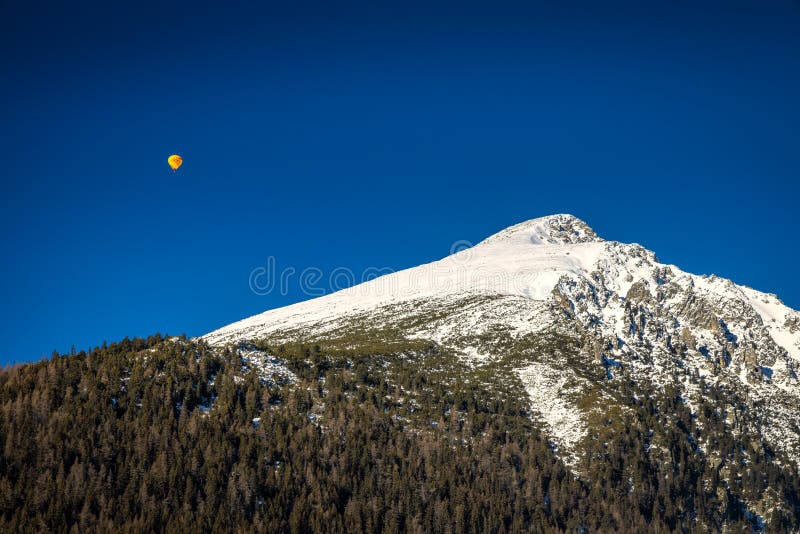 Flying balloon over the snowy mountain Solisko in the High Tatra