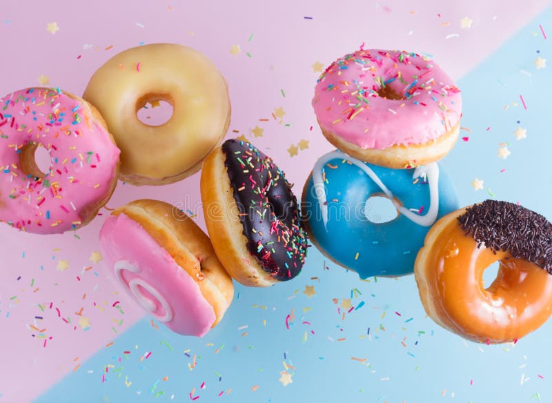 Flying doughnuts on blue stock photography