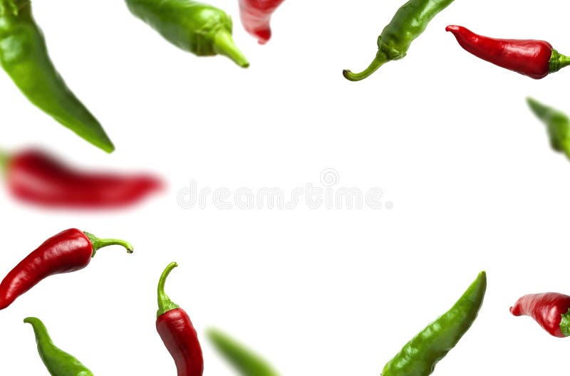 Flying green and red chili pepper isolated on white background. Seasoning for dish, fresh hot pepper, spicy spices for cooking