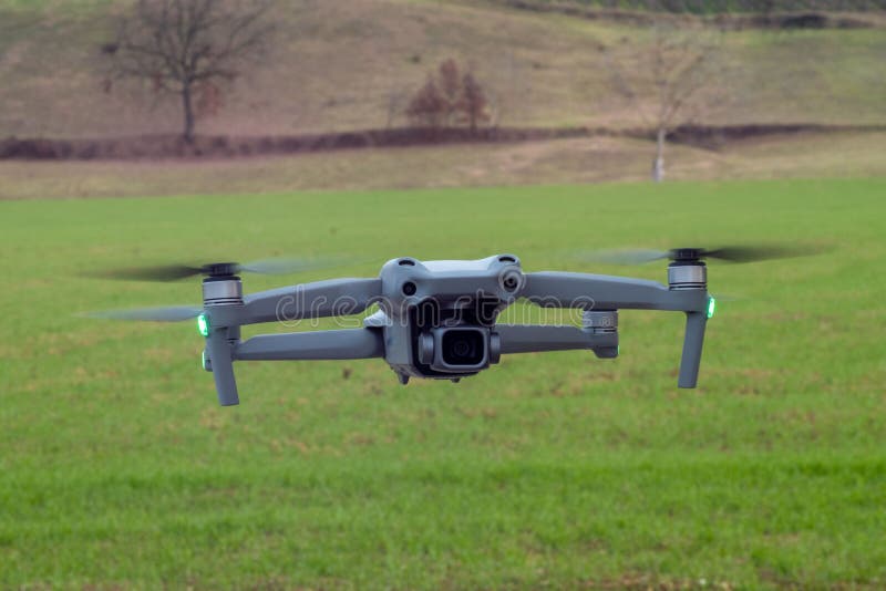 Flying 4k gimbal camera drone hovering over blurred landscape background royalty free stock photos