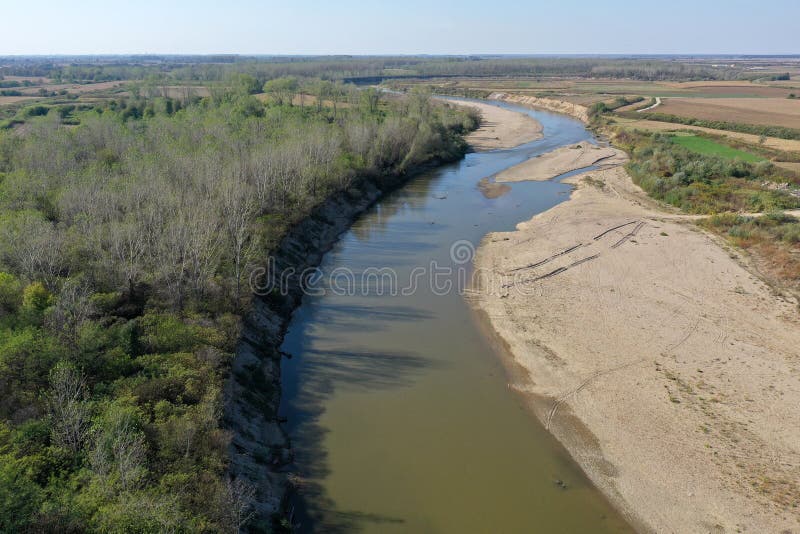 Flying over a river flowing on a plain aerial view royalty free stock images
