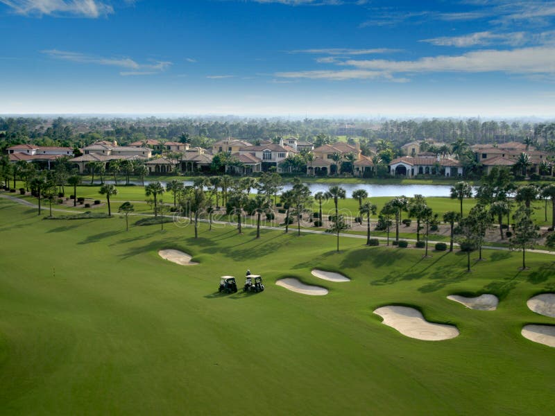 Aerial photograph of a Florida golf course with golfers in the foreground. Aerial photograph of a Florida golf course with golfers in the foreground
