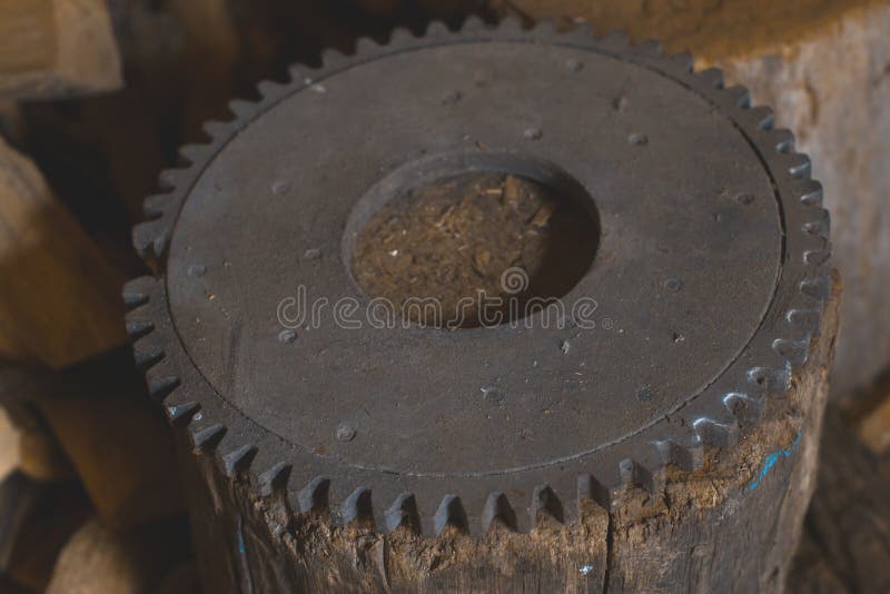 Flywheel old on a wooden stump in the workshop. royalty free stock photos Flywheel old on a wooden stump in the workshop. royalty free stock photos