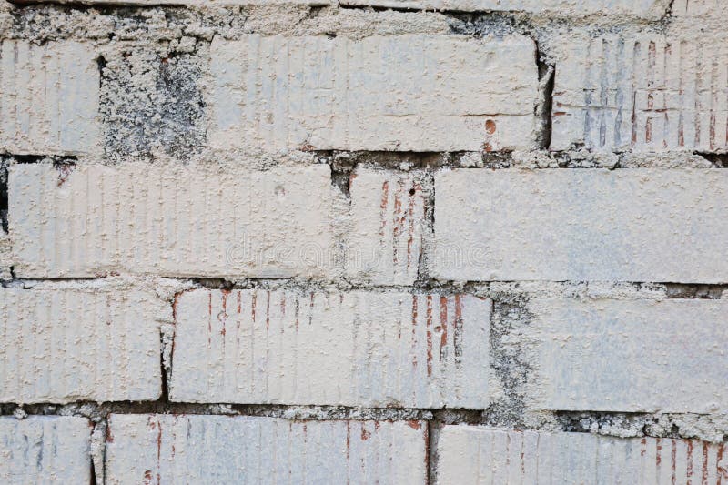 Fläktens textur är grå. Gammal antik övergiven tegelvägg. Struktur för design från kopieringsbrickor.