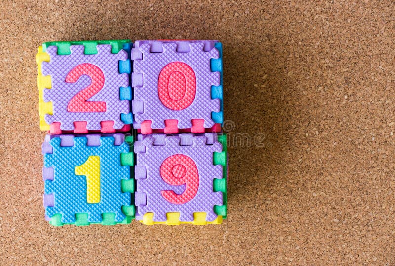 Foam alphabet puzzle in word 2019 on cork board background royalty free stock image Foam alphabet puzzle in word 2019 on cork board background royalty free stock image