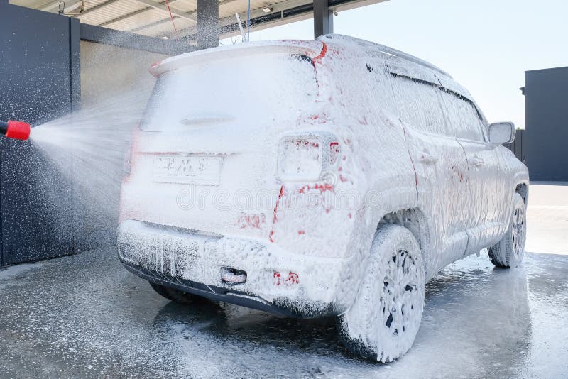 Car in Foam at a Car Wash. Car Wash with Soap, Car Wash Stock Photo