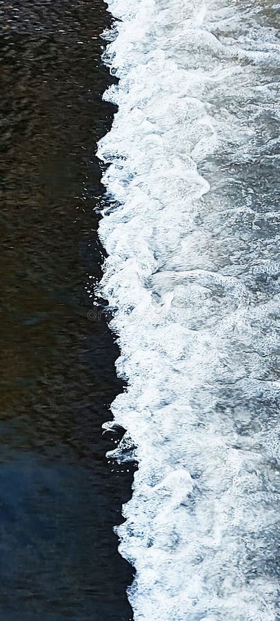 Foam of water that forms a line in the swift flow of the river royalty free stock photography