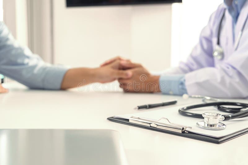 Focus of Medical instruments, stethoscope and doctor touching patient hand for encouragement and empathy on the hospital blurred background, Bad news. Focus of Medical instruments, stethoscope and doctor touching patient hand for encouragement and empathy on the hospital blurred background, Bad news.