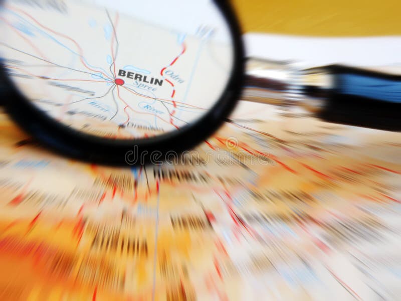 A concept image of a magnifying glass focusing on the city of Berlin in Germany, on a map in an atlas. Horizontal color image, nobody in picture. Atlas book stock images, royalty-free photos and pictures