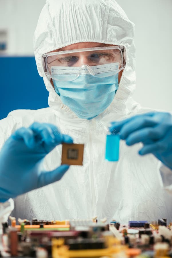 Focus of Engineer Holding Microchip and Glass Container with Blue