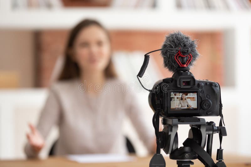 Woman seated in front of camera filming educational video royalty free stock photos Woman seated in front of camera filming educational video royalty free stock photos