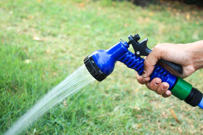 Focus on the hand image Tree sprinkler royalty free stock image