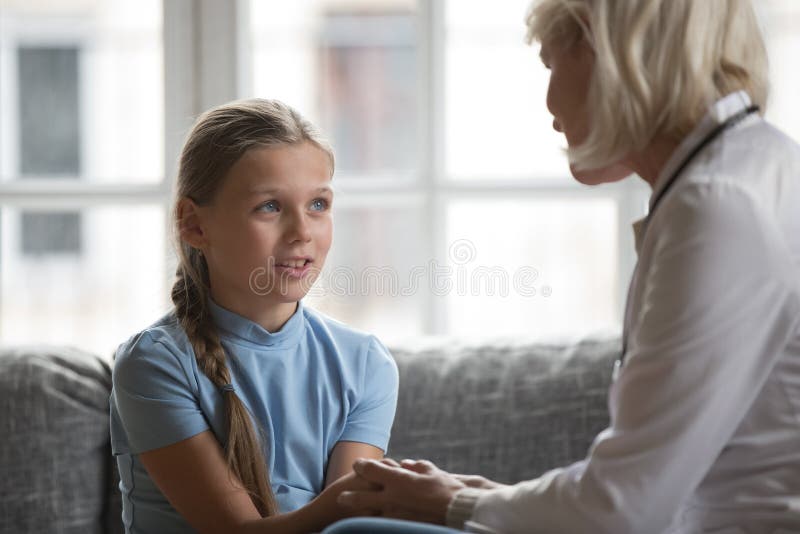 Focus on little girl holding hands aged therapist doctor royalty free stock photography Focus on little girl holding hands aged therapist doctor royalty free stock photography