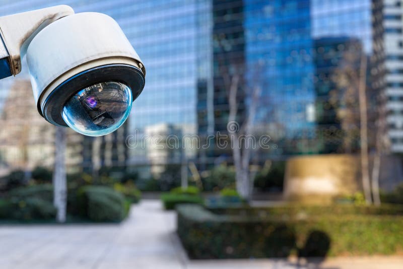 Security CCTV camera or surveillance system with buildings on blurry background royalty free stock photography