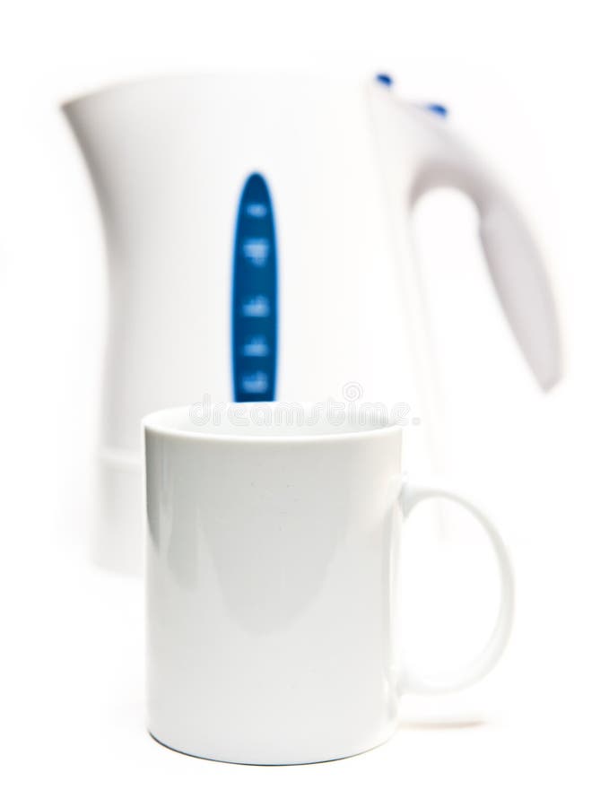 Focus on a Tea Mug. Electric Tea Kettle on a White Background and a Mug