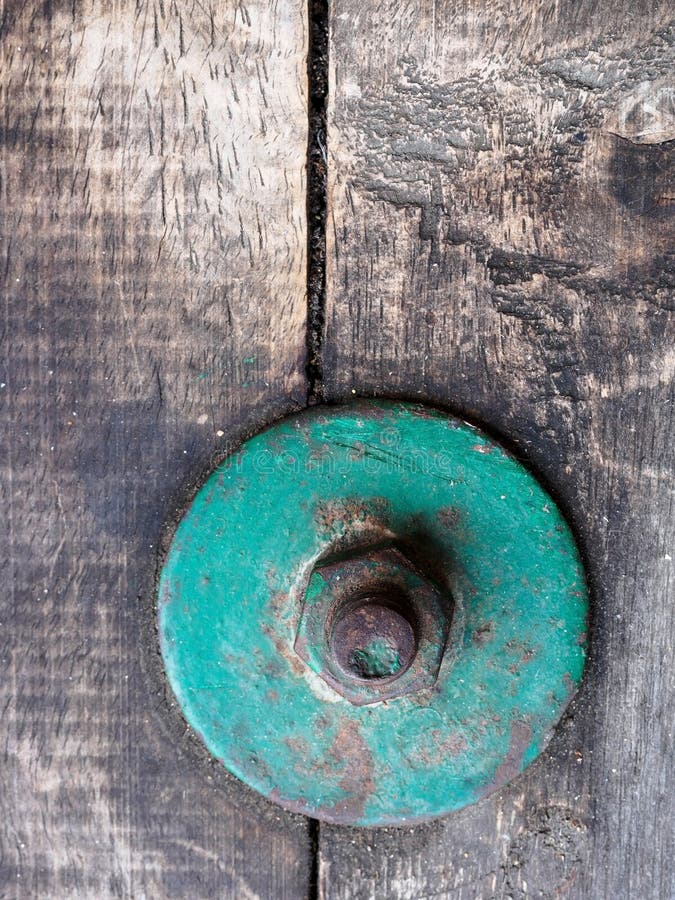 Focus of vintage green bolt on vintage wood stock photos