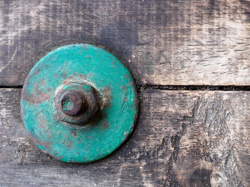 Focus of vintage green bolt on vintage wood stock photos