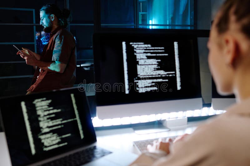 Focus on young male programmer scroling in smartphone royalty free stock image
