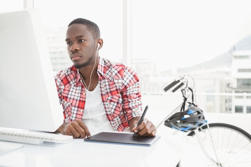 Focused businessman listening music and using digitizer royalty free stock photos