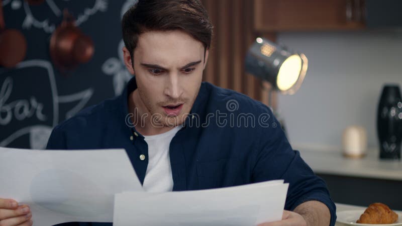 Focused businessman reading documents at home office. Smiling man analyzing data stock photos