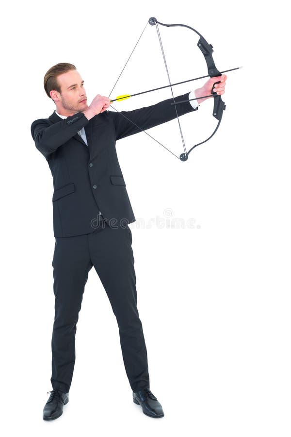 Focused businessman shooting a bow and arrow stock image