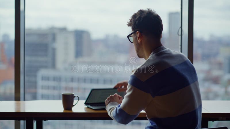 Focused businessman typing laptop panoramic office closeup. Ceo drinking coffee royalty free stock photos
