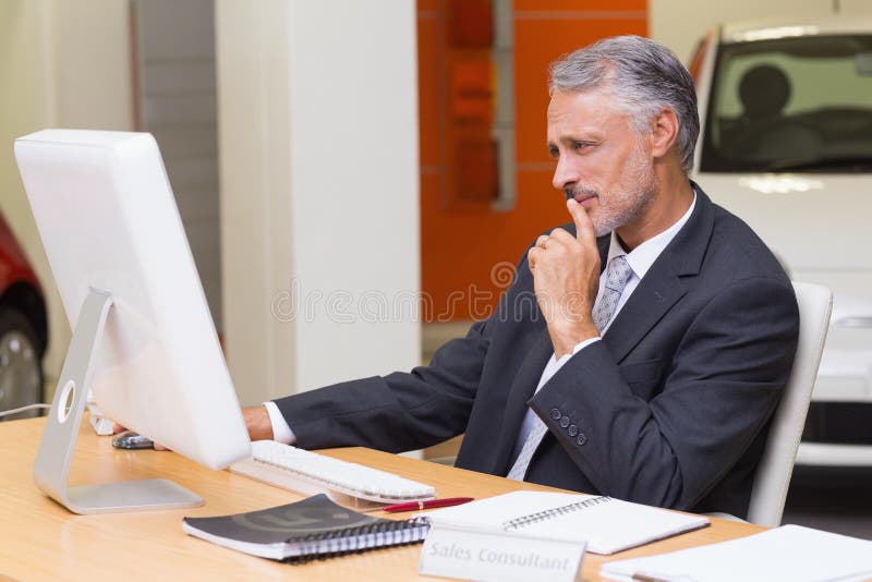 Focused businessman using his laptop stock image