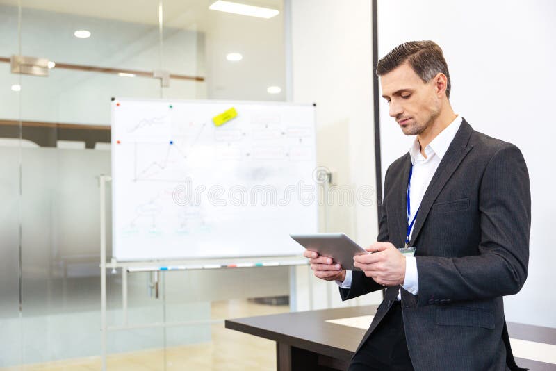 Focused businessman using tablet in office royalty free stock photo
