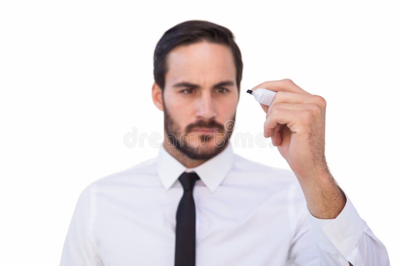 Focused businessman writing with marker stock photos